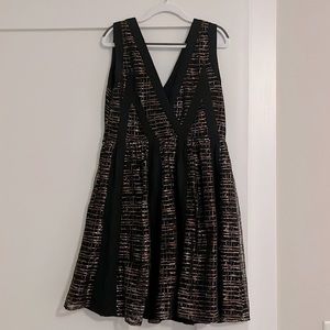 Mid thigh sleeveless dress with plunging V neckline and back. Chiffon.